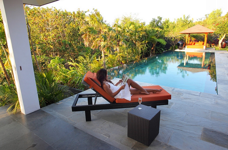 Orange Outdoor Bed by The Swimming Pool Surrounded by a Lush Serene Landscaping