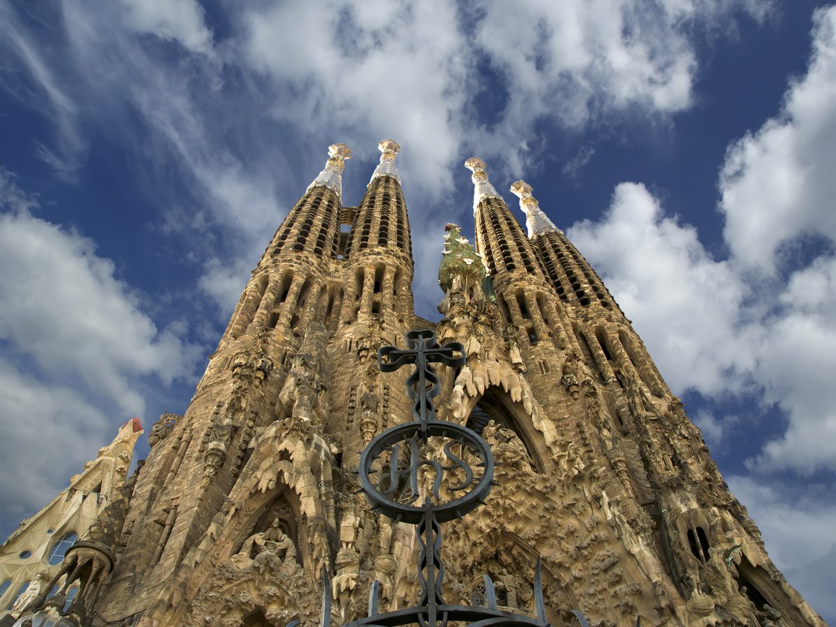 Admire the incredibly detailed facade of the Sagrada Família, a church in Barcelona, Spain, which was designed by famed architect Antoni Gaudí and has been under construction since 1882.