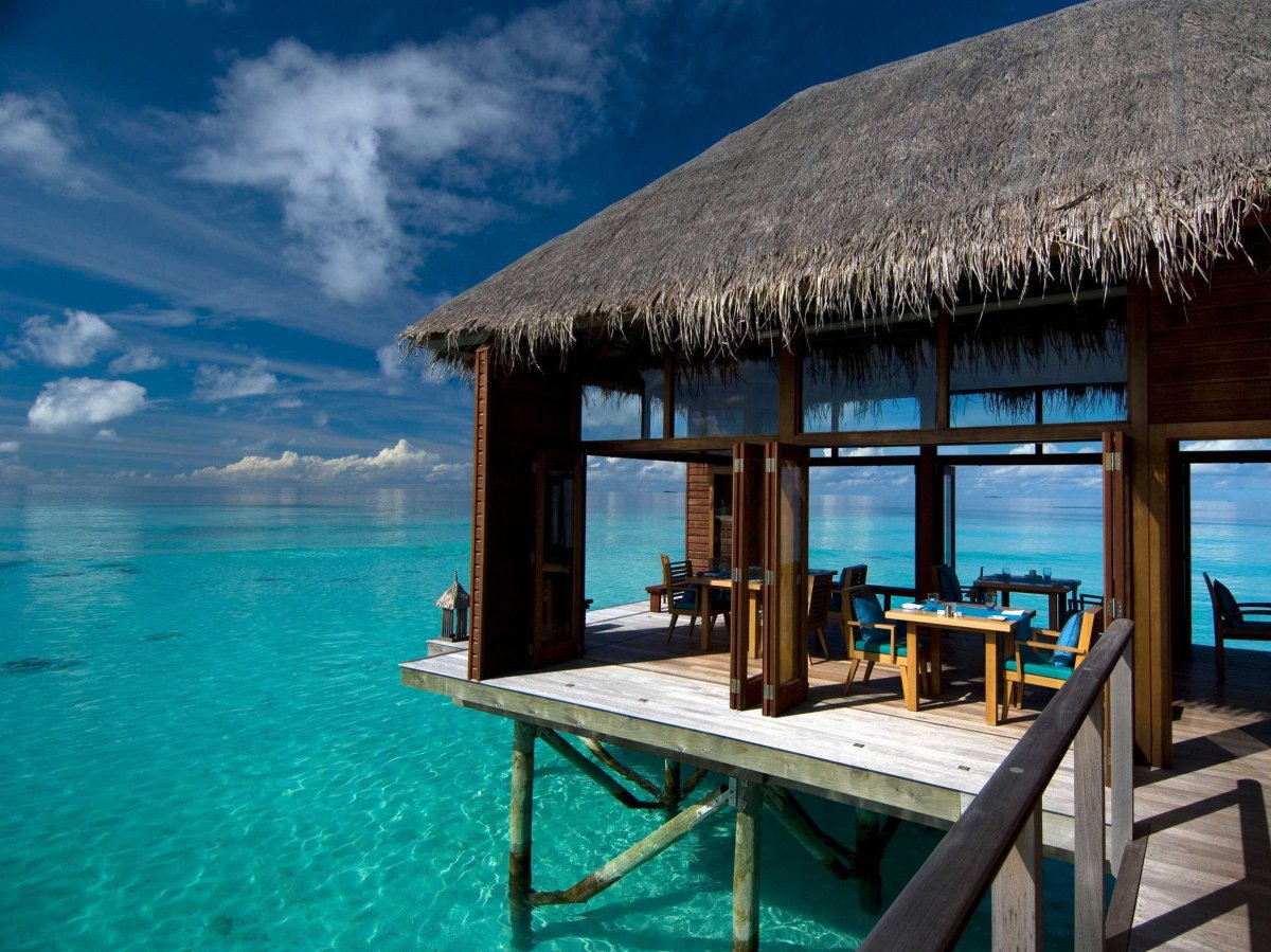 Stay in a luxury hut over the clear aqua waters of the Maldive Islands.