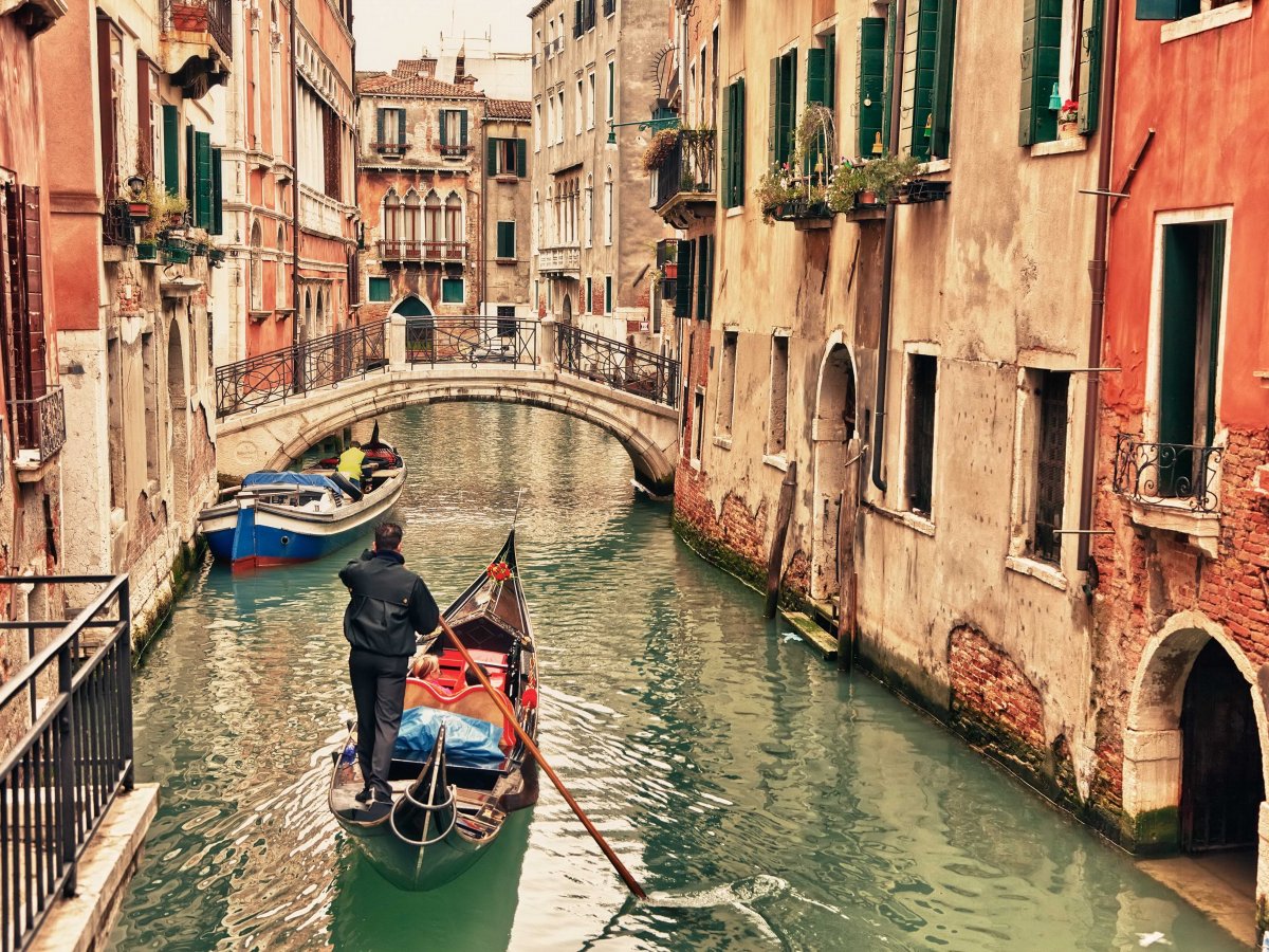 Take a gondola ride through the winding canals of Venice, Italy. 