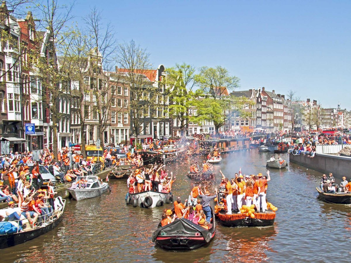 Toast to the royalty of Amsterdam on Queen's Day, when people dress in orange and party all night in The Netherlands' capital.