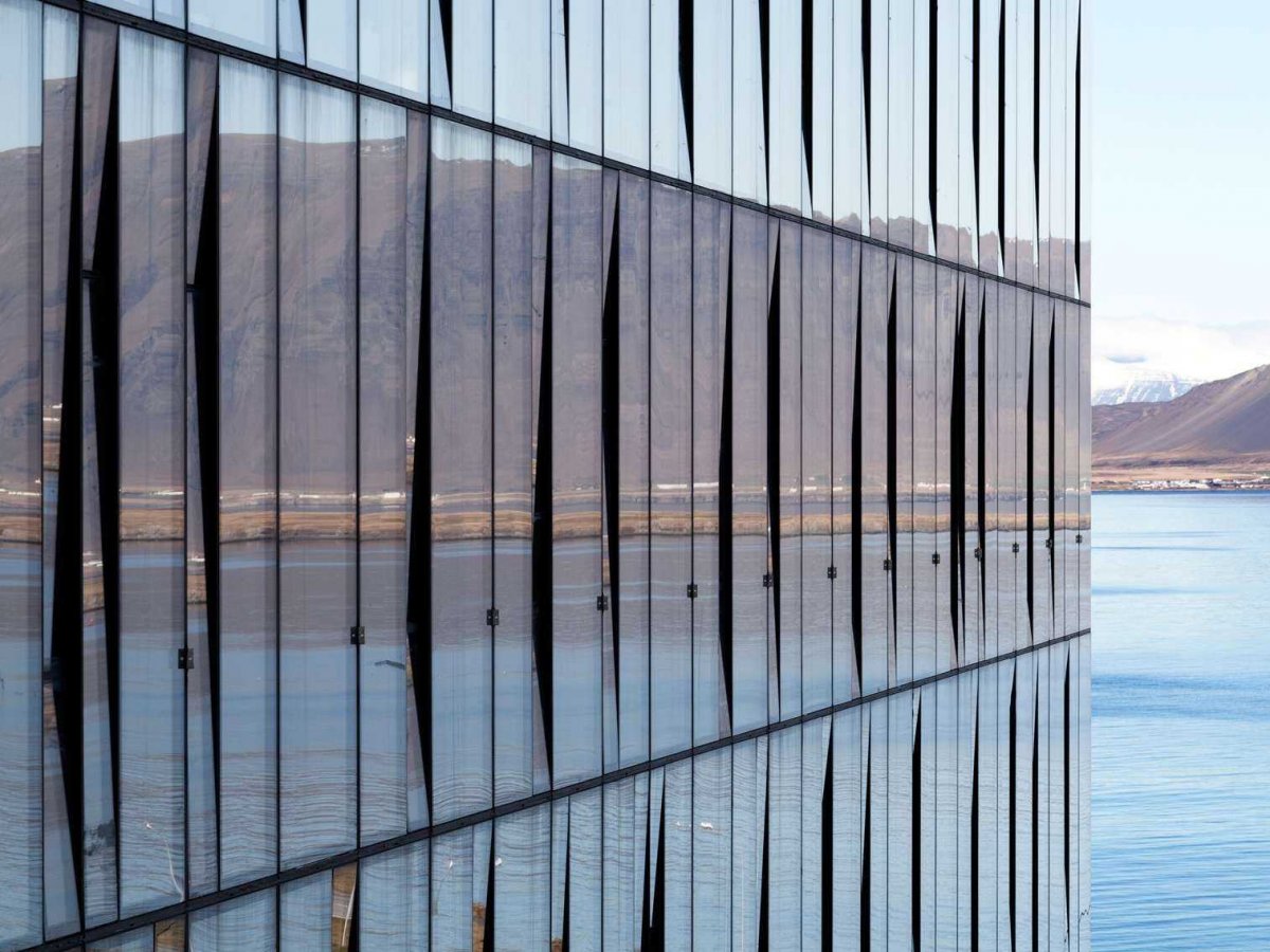 The Turning building in Reykjavík, Iceland, reflects the landscape surrounding the capital, including the Esja Mountain and the Bay of Reykjavik.
