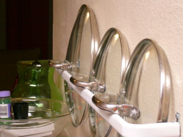 Use a small curtain rod to store lids for easy access