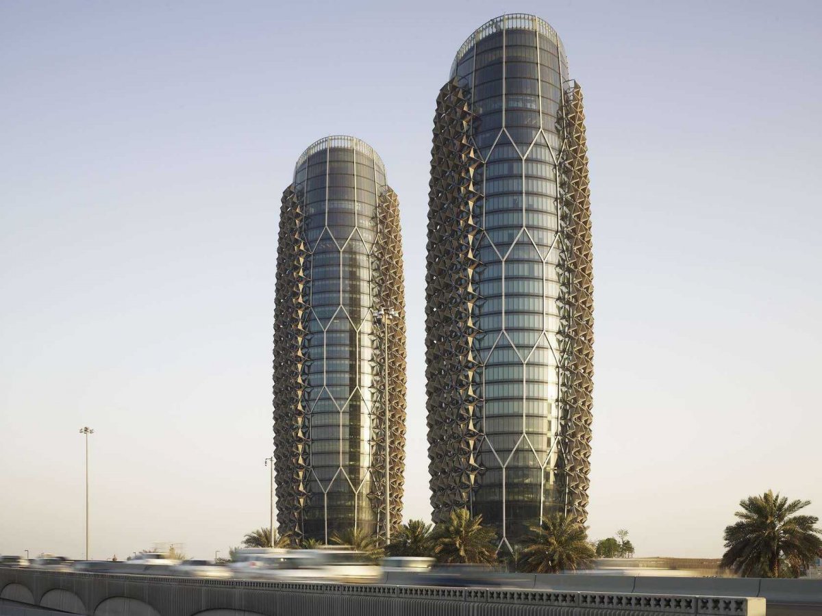 The Al Bahr Towers in Abu Dhabi, UAE, stand 25 stories tall. The lattice design references "Mashrabiya," traditional screens used to gain privacy and shade.