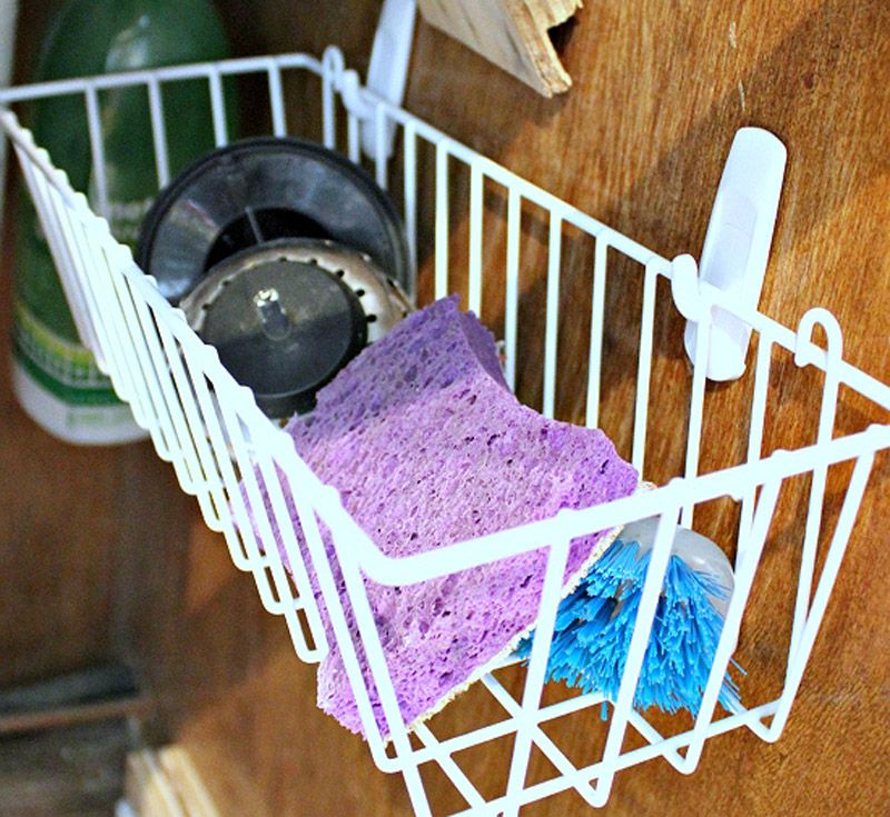 Make all that under-the-sink space work for you with the help of Command hooks and a little basket. Command strips are the easiest and best route for attaching storage to the inside of your cabinets.