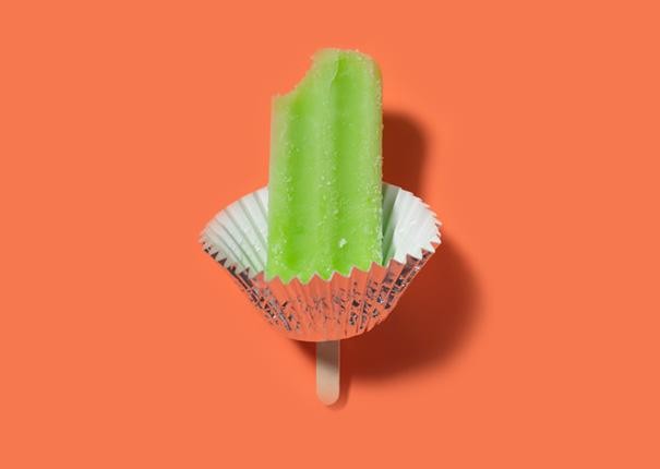 A cupcake holder around a popsicle stick will keep little hands from getting sticky on hot days.