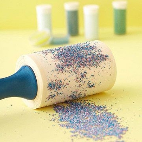 A lint roller picks up glitter (and just about anything else) like a charm!