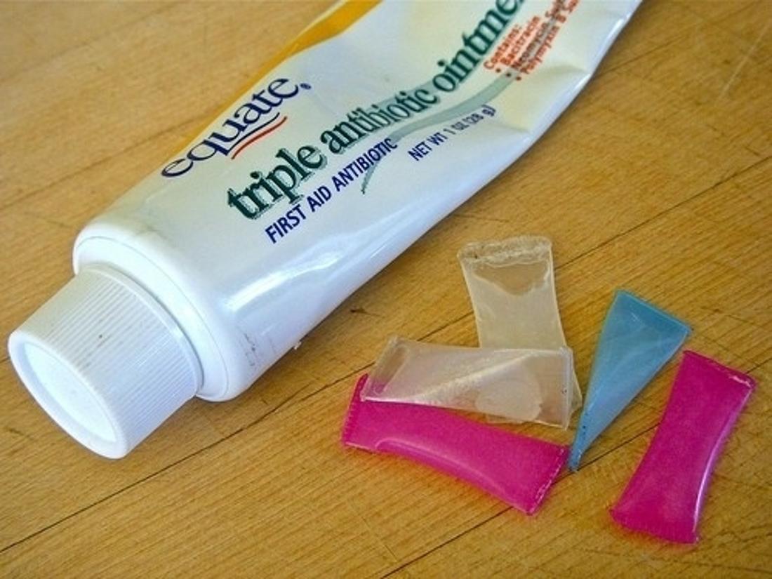 Cut up a straw and fill the pieces with antibiotic ointment or toothpaste for single-use packets.