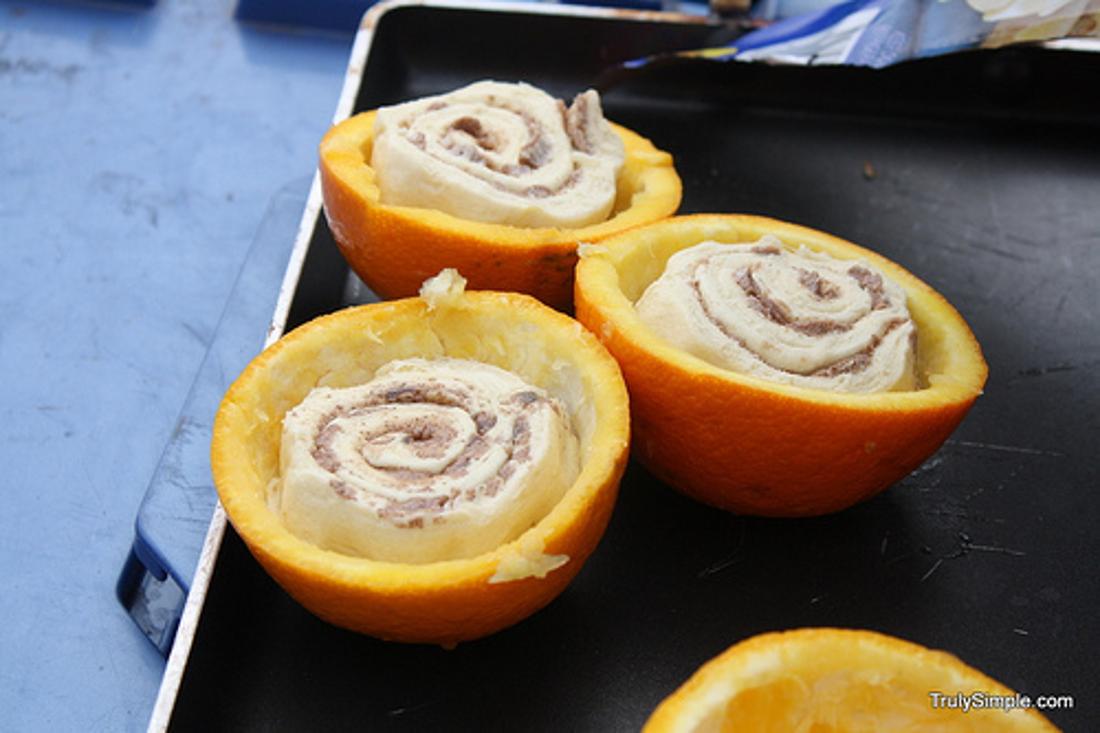 Cook Cinnabuns (the canned kind) in a hollowed-out orange over a campfire.