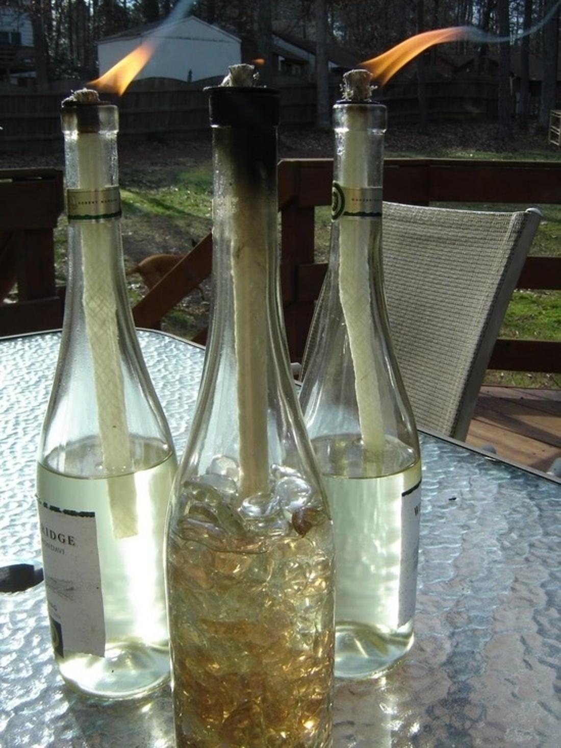 Reuse your empty wine bottles by making mosquito-combating tiki torches.