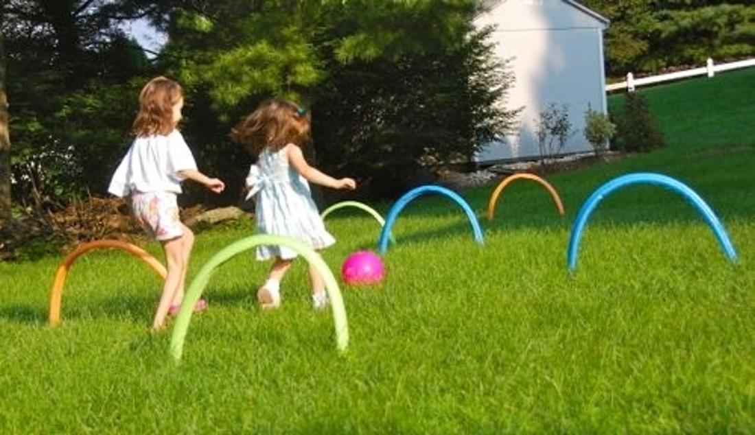 Set up pool noodles for a game of kickball croquet.