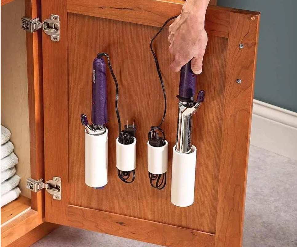 Store Your Hair Appliances With PVC Pipe Attached To The Inside Of A Cabinet