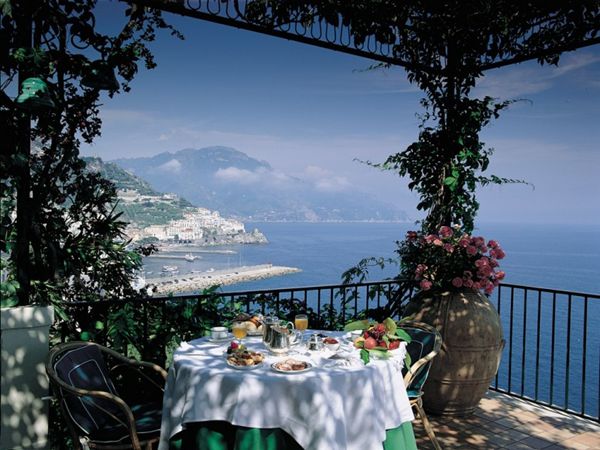 Brunch in dappled sunlight on the terrace with coastal views