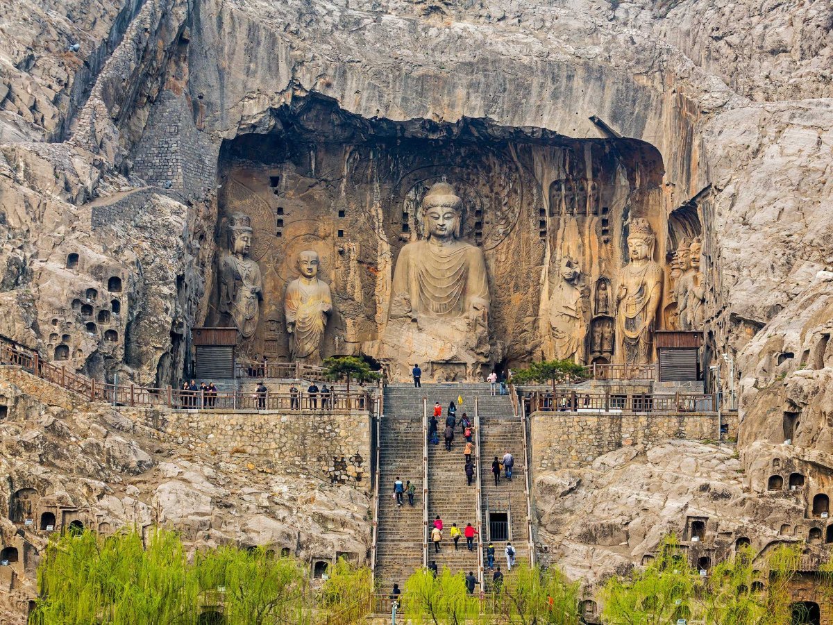 The Longmen Grottoes are found in China's Henan Province and include over 2,300 caves and niches carved into limestone cliffs that stretch more than one kilometer. The caves' statues and inscriptions comprise the most extensive art collection from the Wei and Tang dynasties.