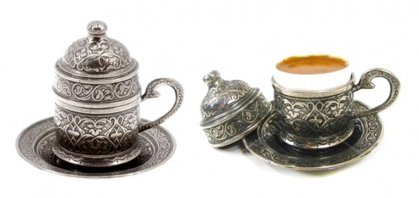 This Turkish espresso cup comes nestled in an ornate container with a matching saucer for an exquisite appearance.