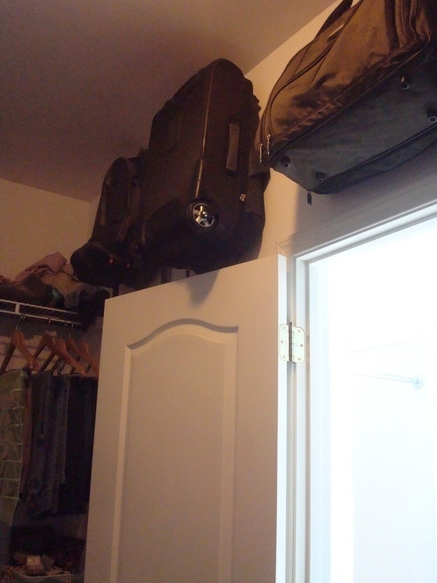 Conserve prime closet space: hang suitcases over the door