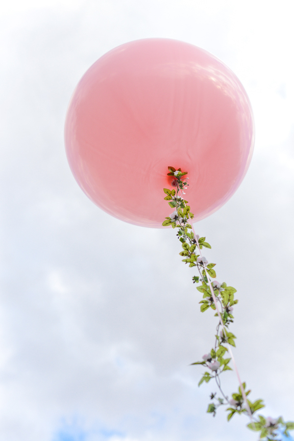 For a spring party, add floral garlands to your balloons.