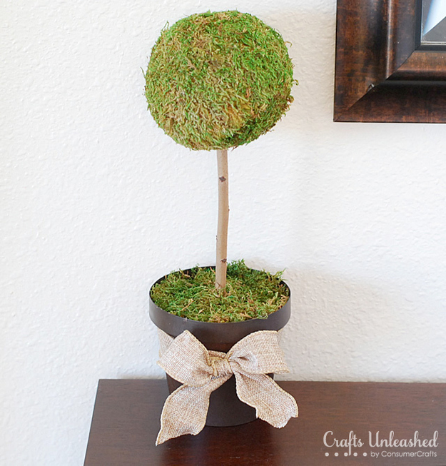 Frame your front door with a couple of grass-green moss topiaries.