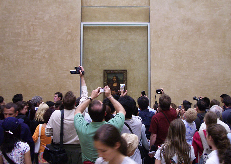 Admiring Mona Lisa In Louvre Museum, Paris, France