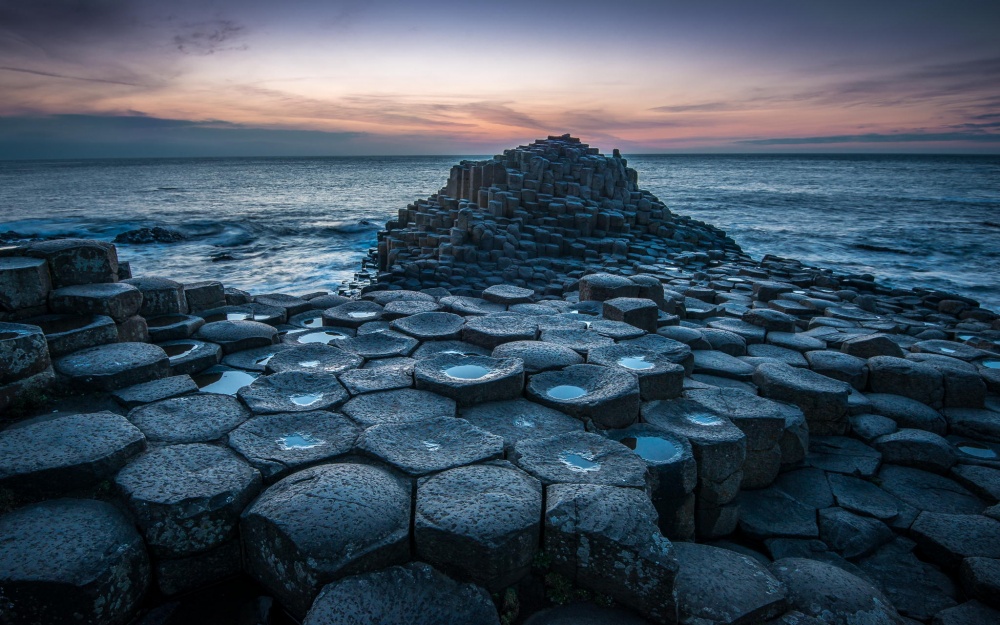 The Giant’s Causeway is a unique coastal area of about 40,000 interlocking basalt columns, the result of an ancient volcanic eruption.