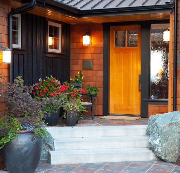 An eclectic entry with flower pots and decorative rocks