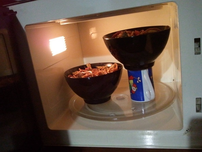 Whenever you want to microwave two bowls at a time, but your microwave is too small, try placing the second bowl on top of a cup.