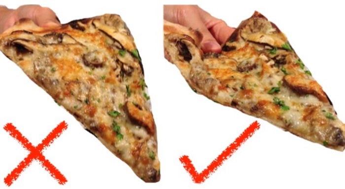 When holding a pizza, there should be a U-shape to prevent it from flopping.