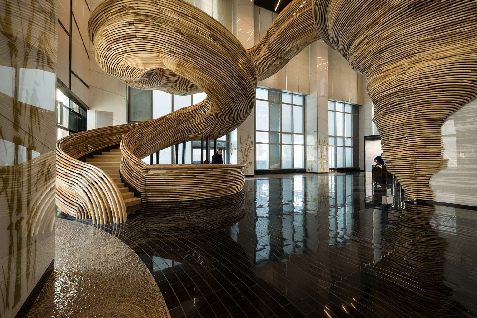 The stair structure comprises two interlocking parts: a skeletal metal staircase and a sculptural wooden envelope.