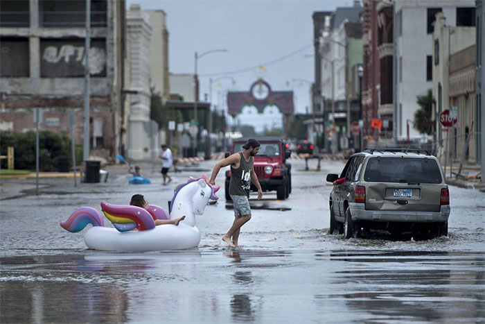 People Make Their Way Down Partially Flooded Roads In Galveston, Texas