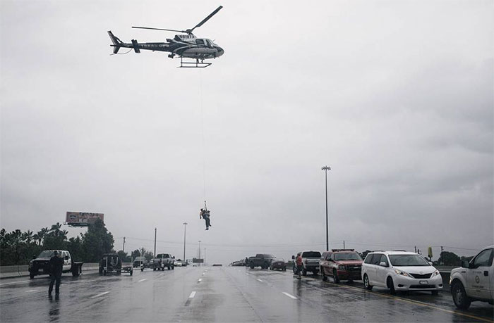 A Helicopter Lifts A Person During Evacuation Of Houston's Meyerland Area