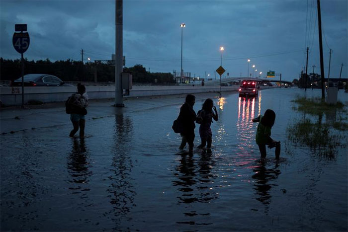 Members Of The Duong Family Walk Through Flood Waters On The Feeder Road Of Interstate 45 In Houston