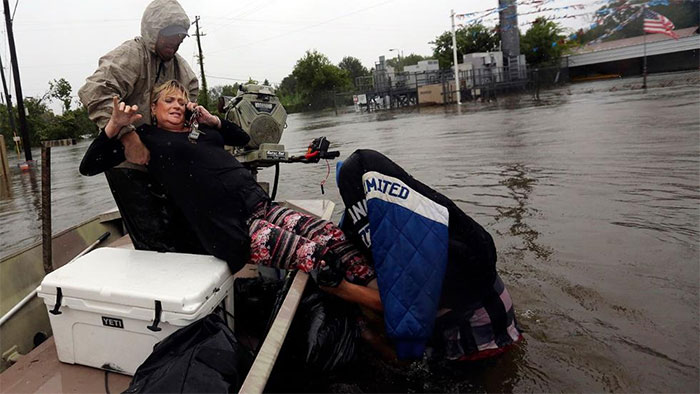 Rhonda Worthington Is Lifted Into A Boat While On Her Cell Phone With A 911 Dispatcher After Her Car Become Stuck In Rising Floodwaters