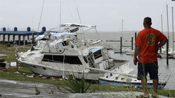 A Man Looks At Boats Damaged By Hurricane Harvey