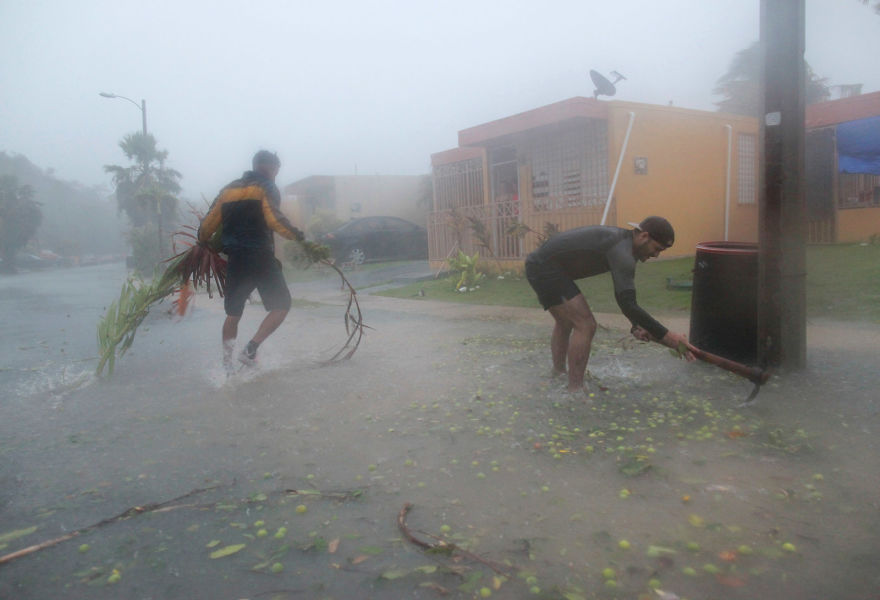 People Pick Up Debris As Hurricane Irma Howls Past In Fajardo, Puerto Rico, On Wednesday