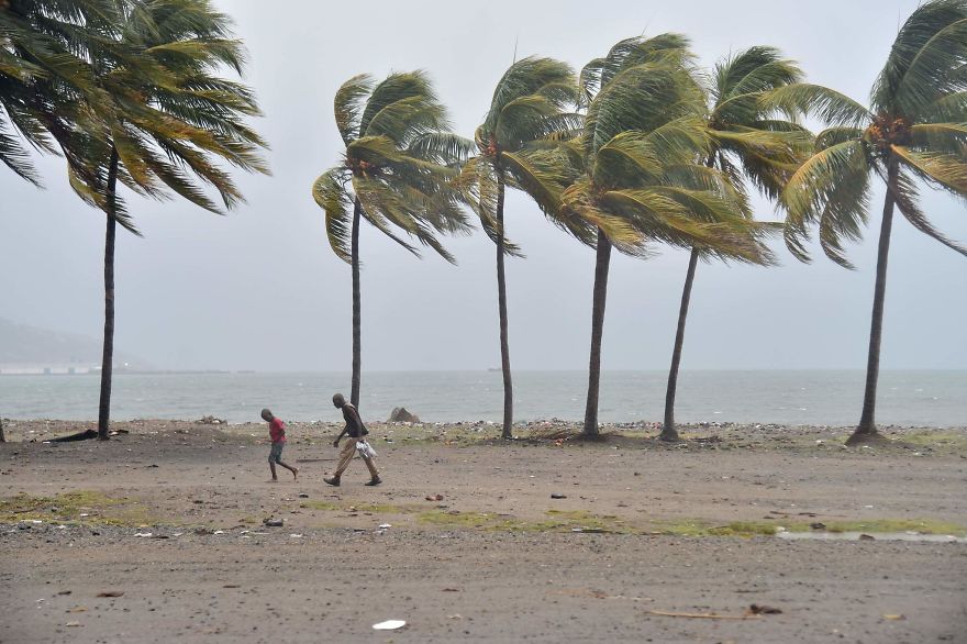 Haitian People Walk Through The Wind And Rain On A Beach, In Cap-Haitien As Hurricane Irma Approaches