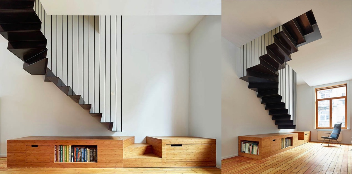 Integrate a staircase into the room by combining it with furniture. This black suspended staircase design stops short of the floor, where a last few wooden treads are amalgamated into a low slung storage cabinet with book nooks.