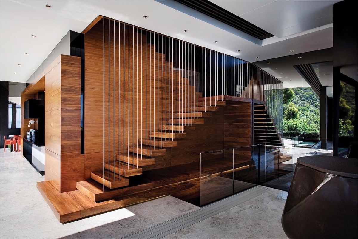 Taller times. Many modern staircases are now favoring taller balustrades that connect the treads directly to the ceiling, creating an encased effect that still lets the visual and the light pass through.