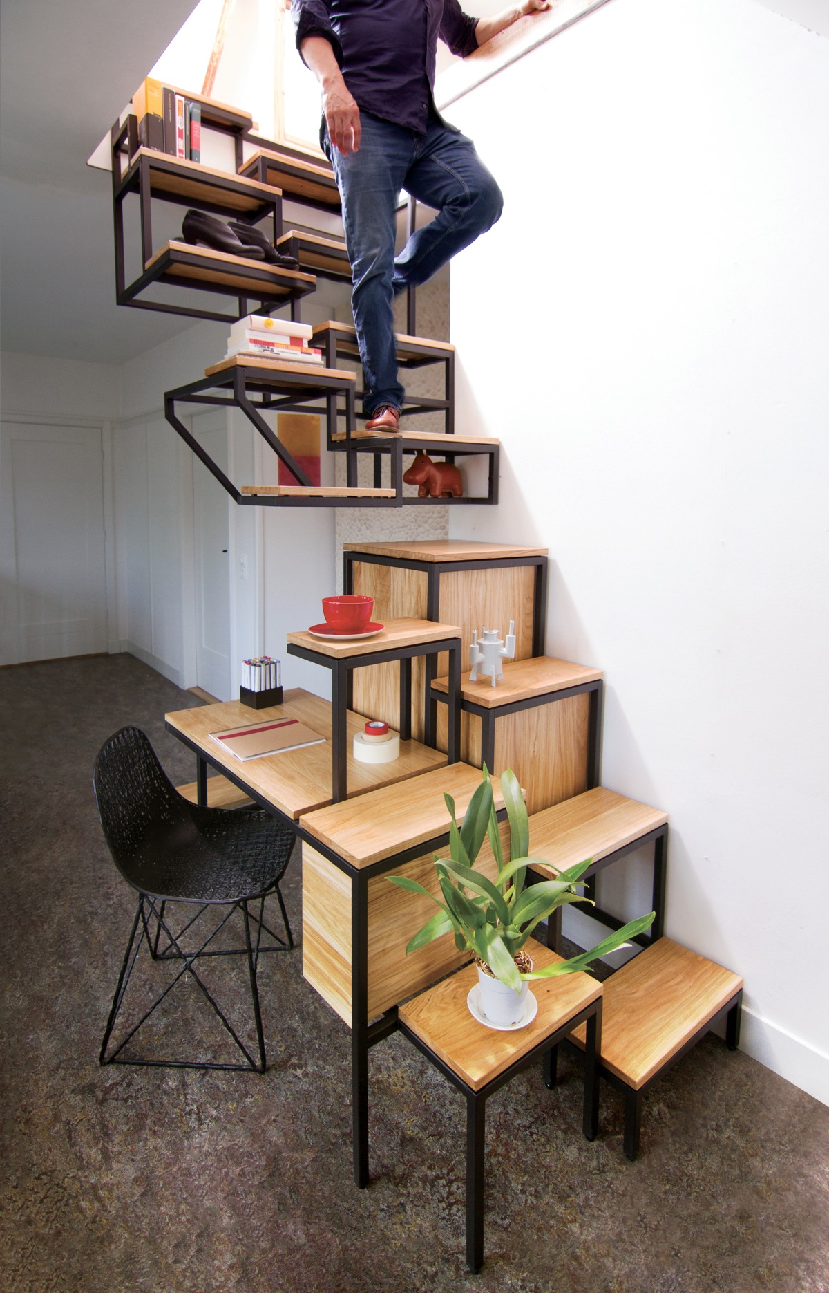 Another home workspace is tucked at the base of this much smaller storage staircase. This one includes a plant stand too.