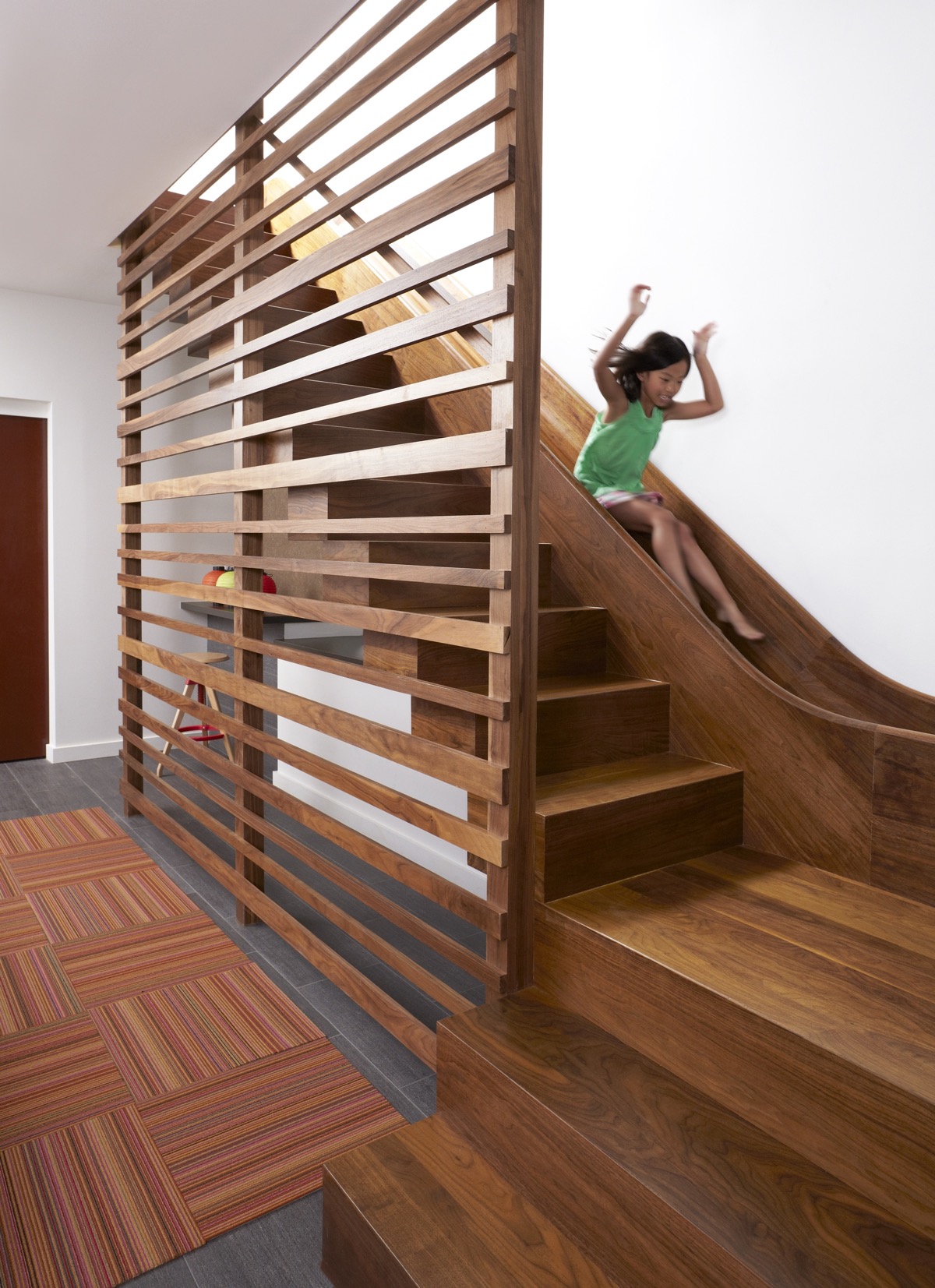 Entertain the child in you – or the children in the family – by incorporating a fun slide into the design. This doesn’t have to look clumsy or garish in childish colors, explore the possibilities in your favored staircase material.