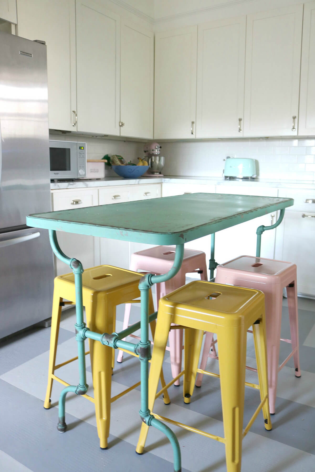 Kitchen with Repurposed Multi-Colored Island Seating