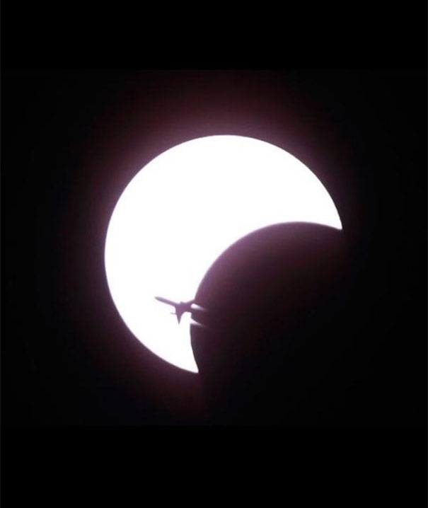 An Airplane Is Silhouetted Against The First Solar Eclipse Of The Decade, Seen Over Bangkok, Thailand, 2010