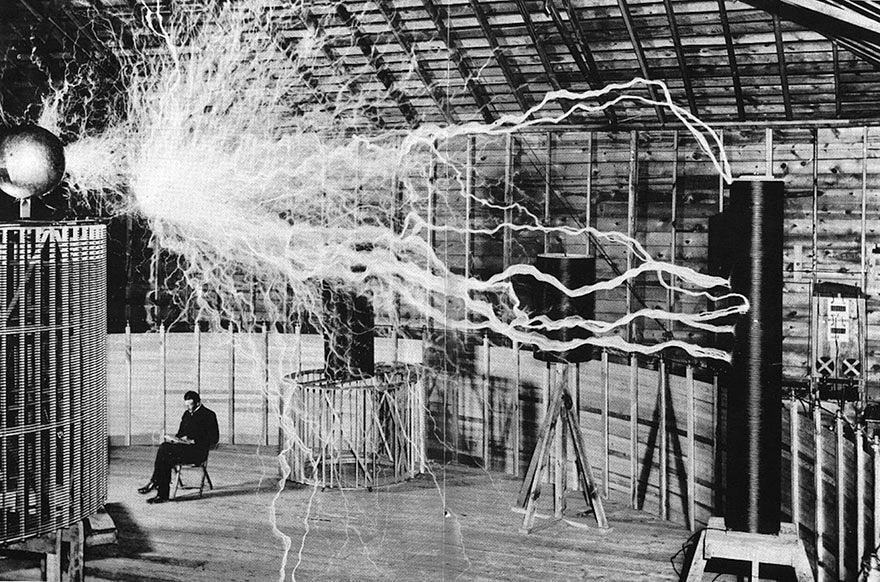 Nikola Tesla Sitting In His Laboratory With His "Magnifying Transmitter."