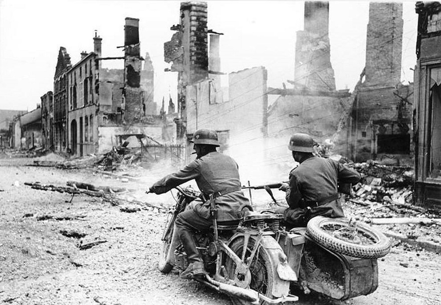 Nazi Motorcyclists Pass Through A Destroyed Town In France During 1940