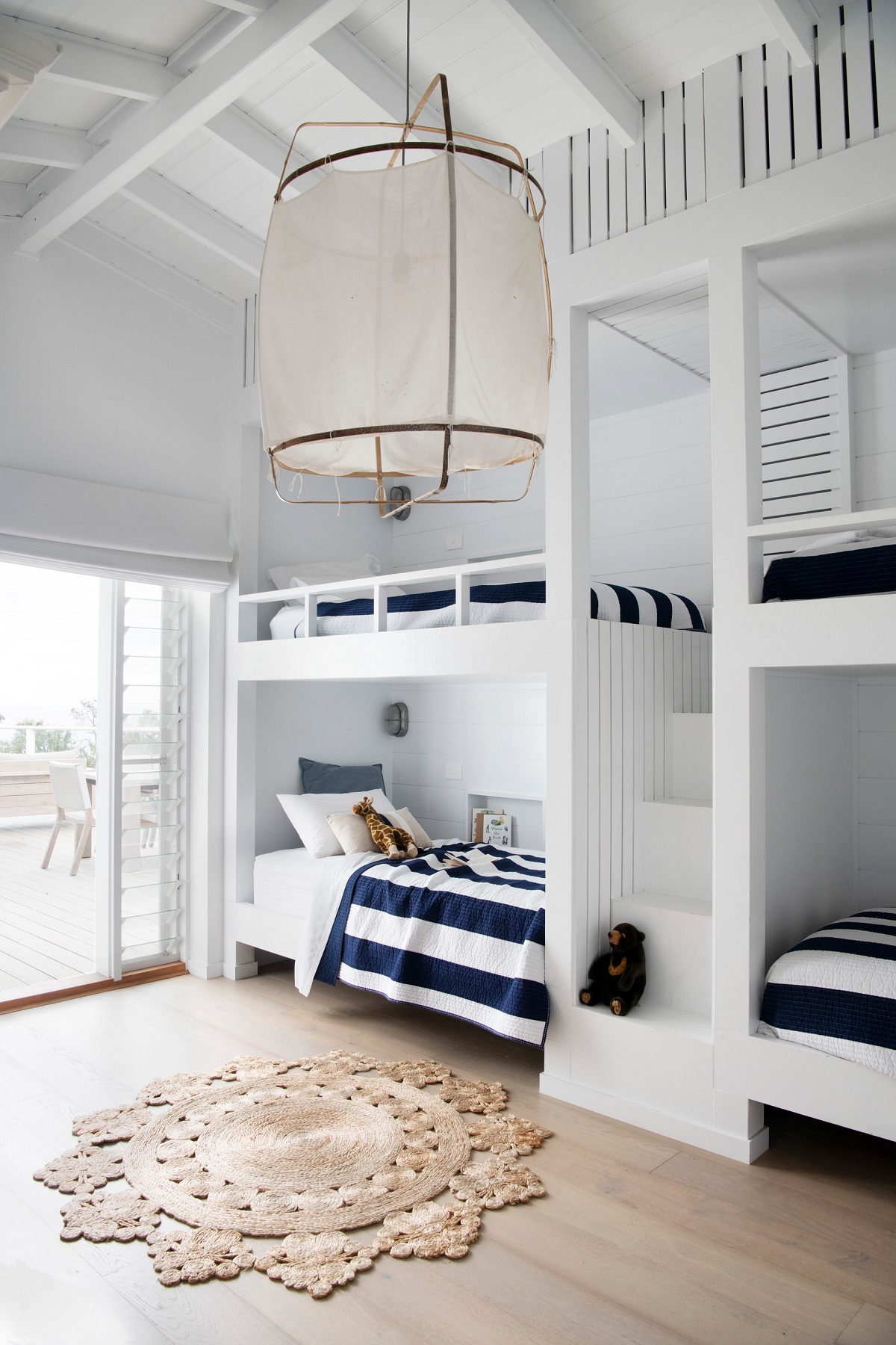 The nautical-style kids' bedroom brings a ship's cabin to mind and promises hours of salty fun spent on holidays in this fresh, airy south coast beach house. Each bunk has its reading light and a nook recessed into the wall to store holiday books and treasures.