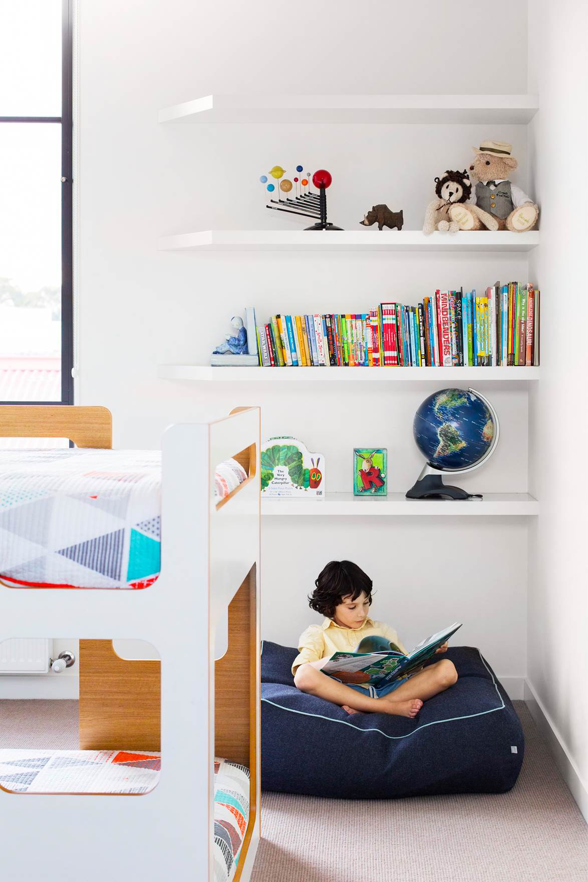 With three young children to accommodate in their chic house, comedian/radio host Dave Hughes and wife Holly Ife prioritized space and an open layout that could meet the family's needs as it evolved. The low-set bunk bed from Domayne in the children's bedroom provides safe and practical sleeping zones.