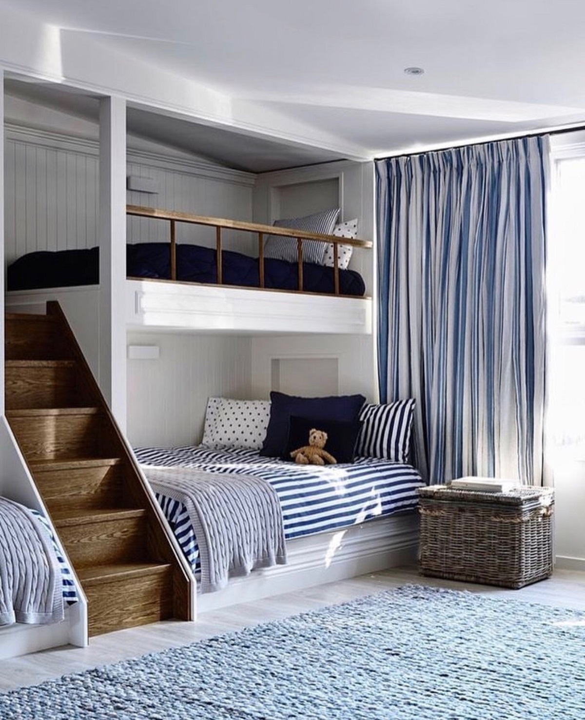 This coastal-style children's room designed by Adelaide Bragg boasts a luxe version of a bunk bed. The custom built-in beds are spacious, with the bottom bunk able to accommodate a double mattress.