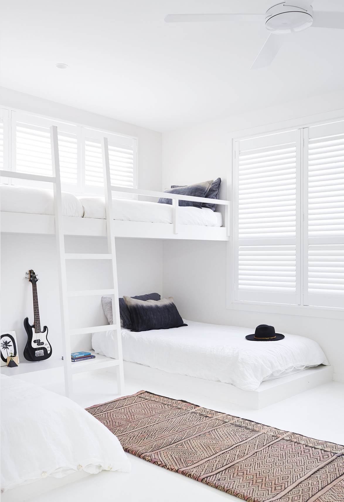 While an all-white palette for a kid's room might sound risky, this renovated Byron Bay home features stark white throughout the house. In the boy's room, a custom elevated bunk system was created to accommodate sleepovers and provide an extra play area.