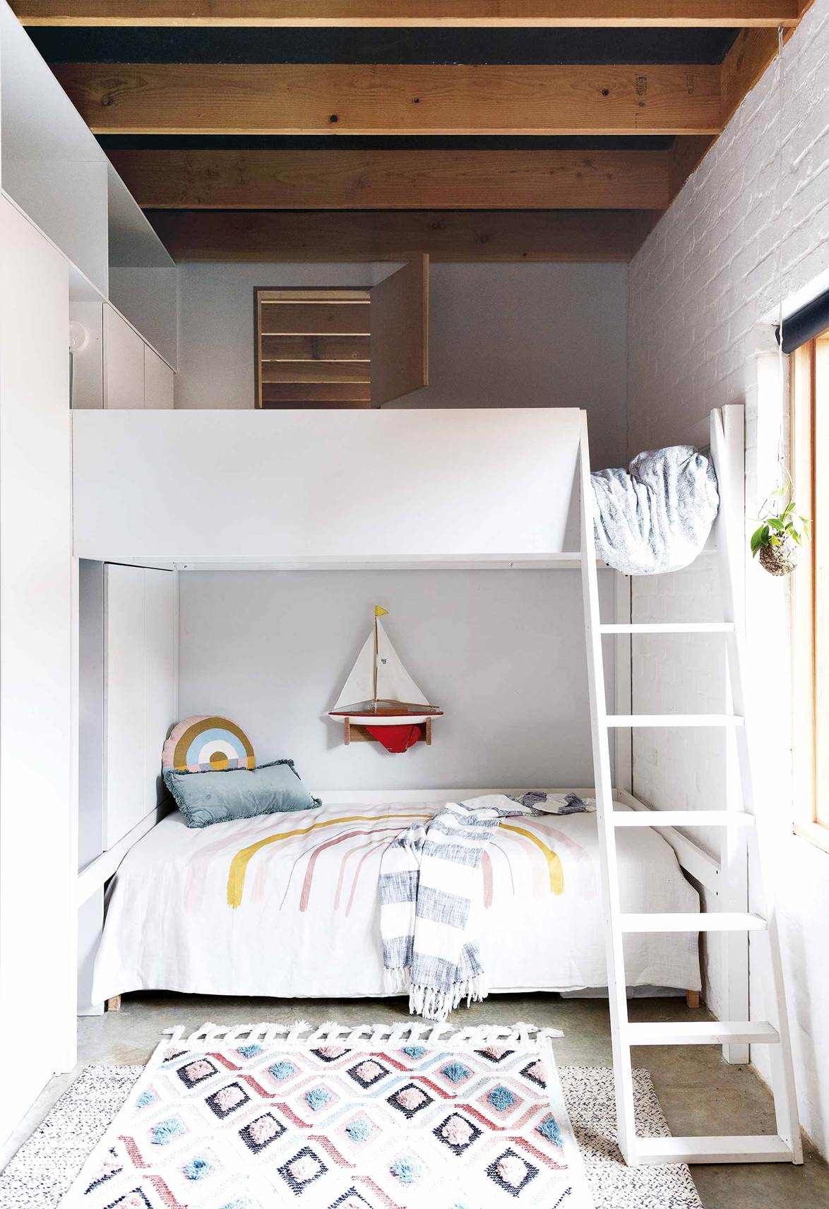 In the build of this small eco-friendly home in Perth, a custom double bunk bed was created to make the most of the compact footprint and tall ceilings of this kid's bedroom.
