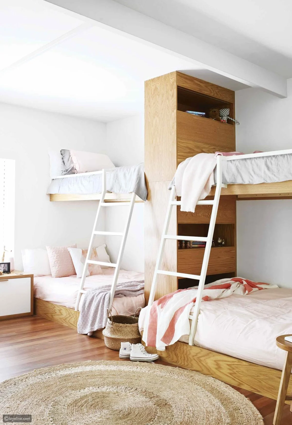 This renovated beach house in Noosa features a curious kids' bedroom configuration involving twin custom bunk beds. With four daughters, two of whom now live out of home, this space was designed to encourage communication and connection between the children.