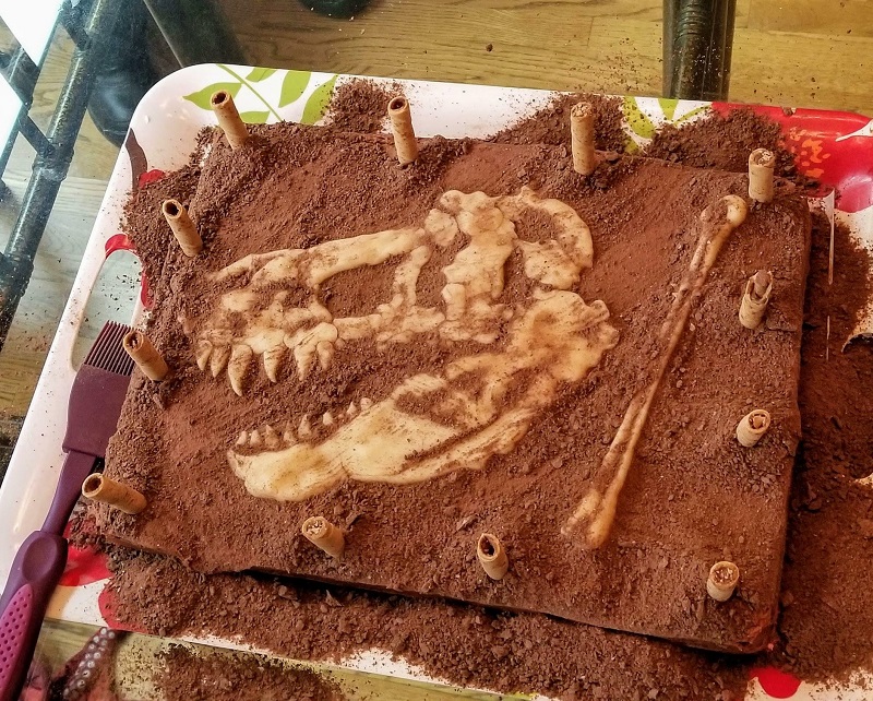 Chocolate Birthday Cake Decorated To Look Like A Dig Site, With Marzipan Fossils Hidden Beneath Crumb "Dirt."